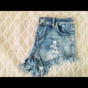 Mid rise destructed denim shorts